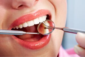 mouth being dental checked with dental tools